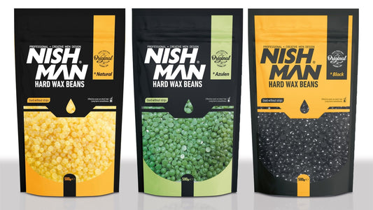 Three packages of Nish Man hard wax beans in different colors on a white background