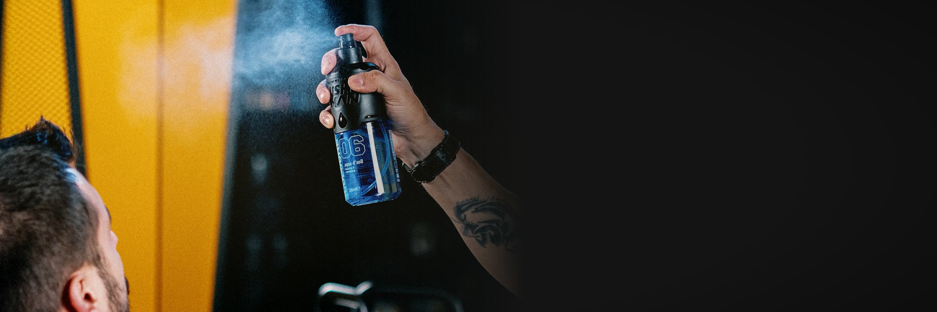 Barber applying Nishman spray in a barbershop